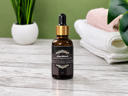 Naiga Naturals Beard Growth Oil 30ml amber dropper bottle on a wooden surface with a plant and folded towels